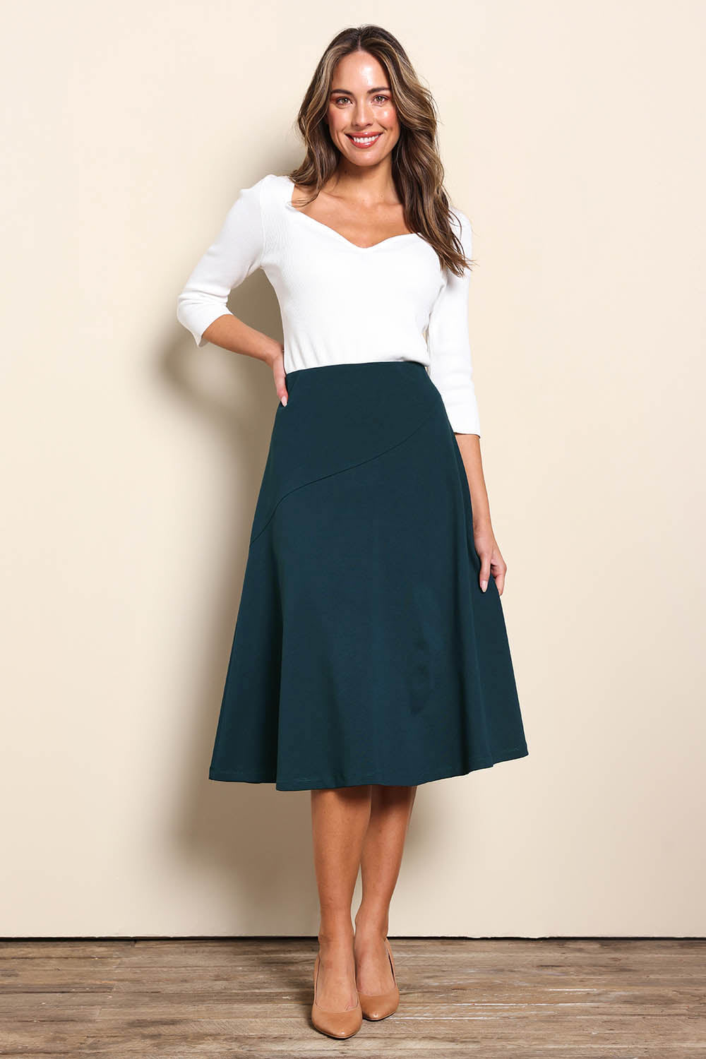 Model Madelinec wearing size 10 of the The Ponte Curve Seam Pull On Skirt – Lagoon in colour Lagoon, from the front