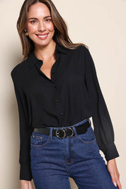 Model Madelinec wearing size 10 of the The Allure Georgette Shirt – Black in colour Black, in a cropped view