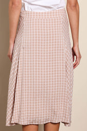 Model Madelinec wearing size 10 of the The Bias Panel Check Skirt - Sand in colour Sand, from the back