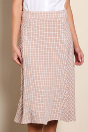 Model Madelinec wearing size 10 of the The Bias Panel Check Skirt - Sand in colour Sand, in a cropped view