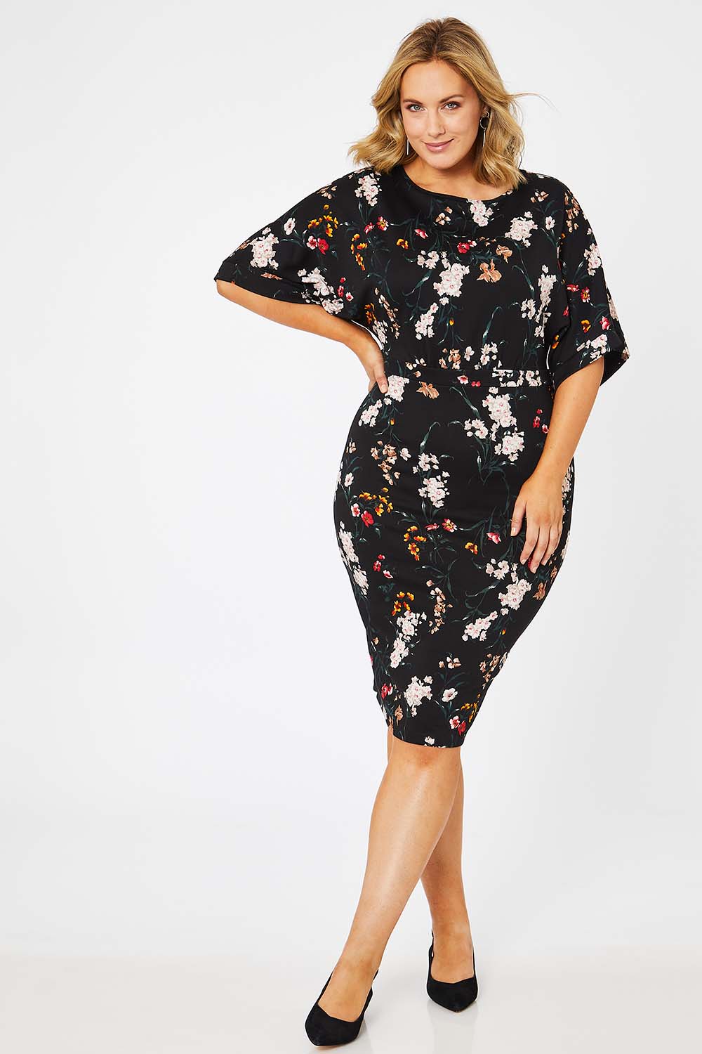 Model Jess wearing size 14 of The Printed Kimono Sleeve Pencil Dress in colour Garden (Black), from the front, showing the whole outfit