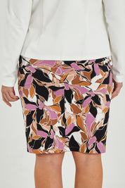 Model Maddy wearing size 16 of The Tube Skirt in colour Abstract, from the back