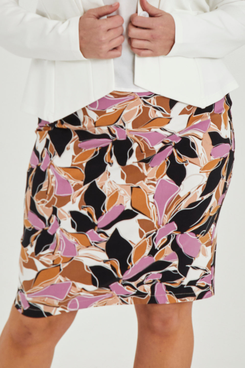 Model Maddy wearing size 16 of The Tube Skirt in colour Abstract, from the front, cropped image