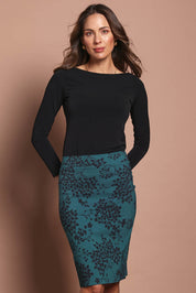 Model Madeline wearing size 10 of The Tube Skirt in colour Tealbloom (Green), from the front, cropped image