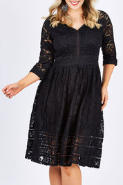 Model Jess wearing size 14 of The 3/4 Sleeve Lace Dress in colour Black (Black), from the front, cropped image