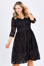 Model Jess wearing size 14 of The 3/4 Sleeve Lace Dress in colour Black (Black), from the front, cropped image
