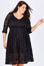 Model Mae wearing size 18 of The 3/4 Sleeve Lace Dress in colour Black (Black), from the front, cropped image