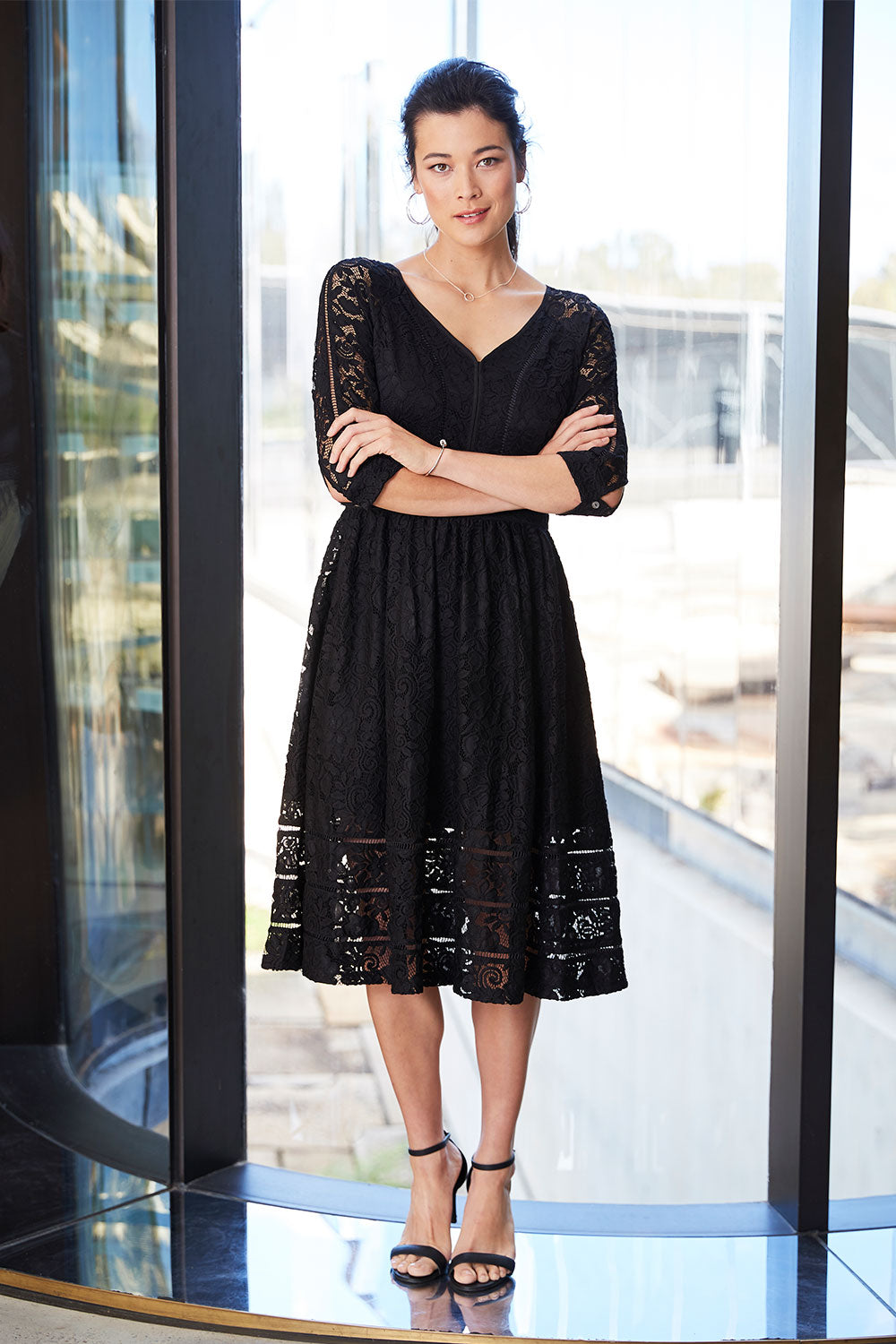 Model Miranda wearing size 8 of The 3/4 Sleeve Lace Dress in colour Black (Black), from the front, showing the whole outfit