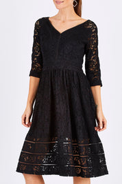 Model Monique wearing size 8 of The 3/4 Sleeve Lace Dress in colour Black (Black), from the front, cropped image
