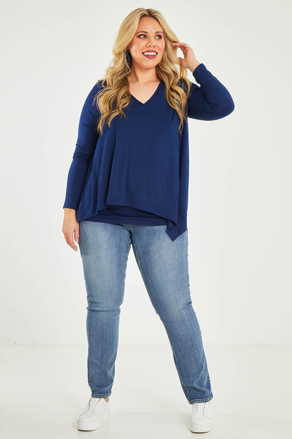 Model Katie wearing size 16 of the Belle V Neck Forgiver Tunic in colour Navy (Blue), from the front, showing the whole outfit