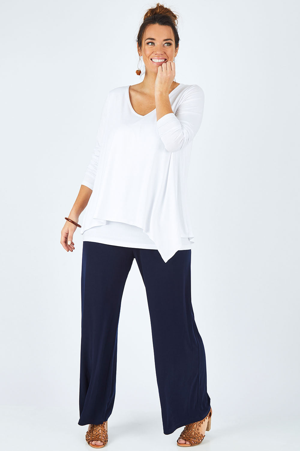 Model Laura wearing size 12 of the Belle V Neck Forgiver Tunic in colour White (White), from the front, showing the whole outfit