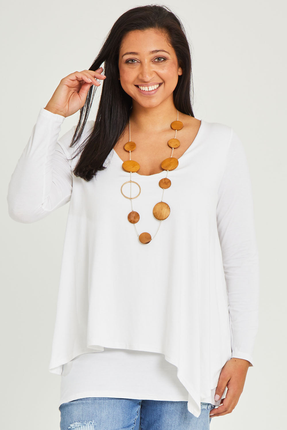 Model Terri-Leigh wearing size 14 of the Belle V Neck Forgiver Tunic in colour White (White), from the front, cropped image