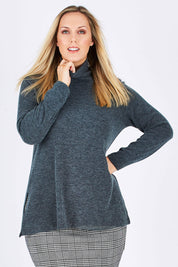 Model Jess wearing size 12 of the Belle Cowl Swing Sweater in colour Green (Green), from the front, cropped image