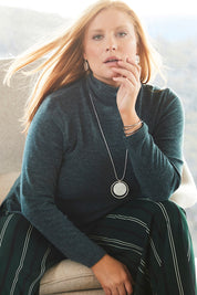 Model Mercy wearing size 12 of the Belle Cowl Swing Sweater in colour Green (Green), from the front, showing the whole outfit