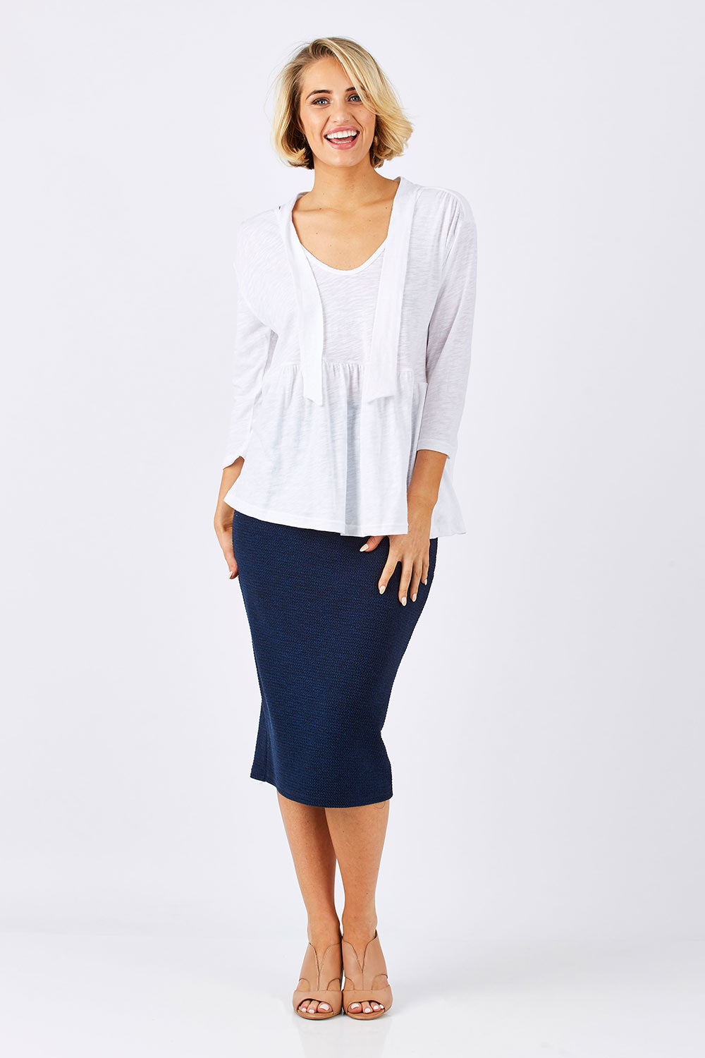 Model Emma wearing size 10 of the Belle Textured Pencil Skirt in colour Navy (Blue), from the front, showing the whole outfit