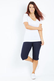 Model Laura wearing size 12 of the Belle Knee Short in colour Navy (Blue), from the front, showing the whole outfit