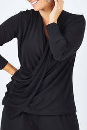 Model Laura wearing size 12 of the Belle Drape Tee in colour Black (Black), from the front, cropped image