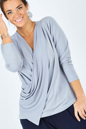 Model Laura wearing size 12 of the Belle Drape Tee in colour Sliver (Grey), from the front, cropped image