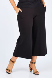 Model Jess wearing size 14 of the Belle Palazzo Ponte Crop in colour Black (Black), from the front, cropped image