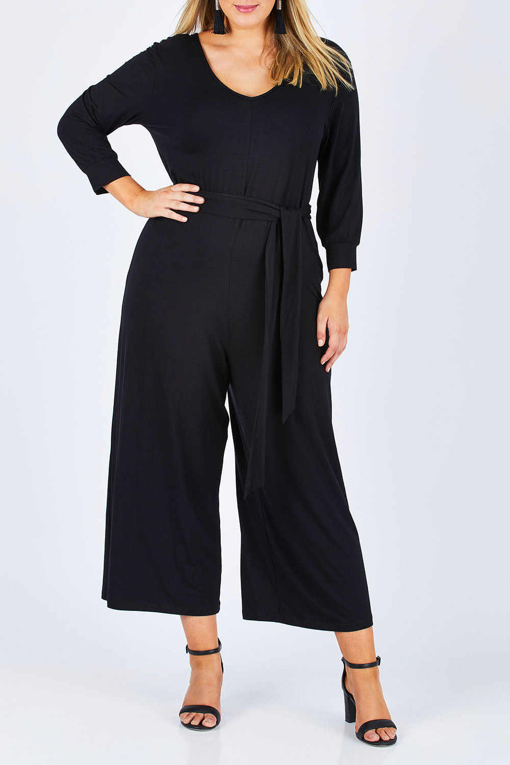 Model Jess wearing size 14 of the Belle 7/8 Sleeve Knit Jumpsuit With Self Belt in colour Black (Black), from the front, cropped image