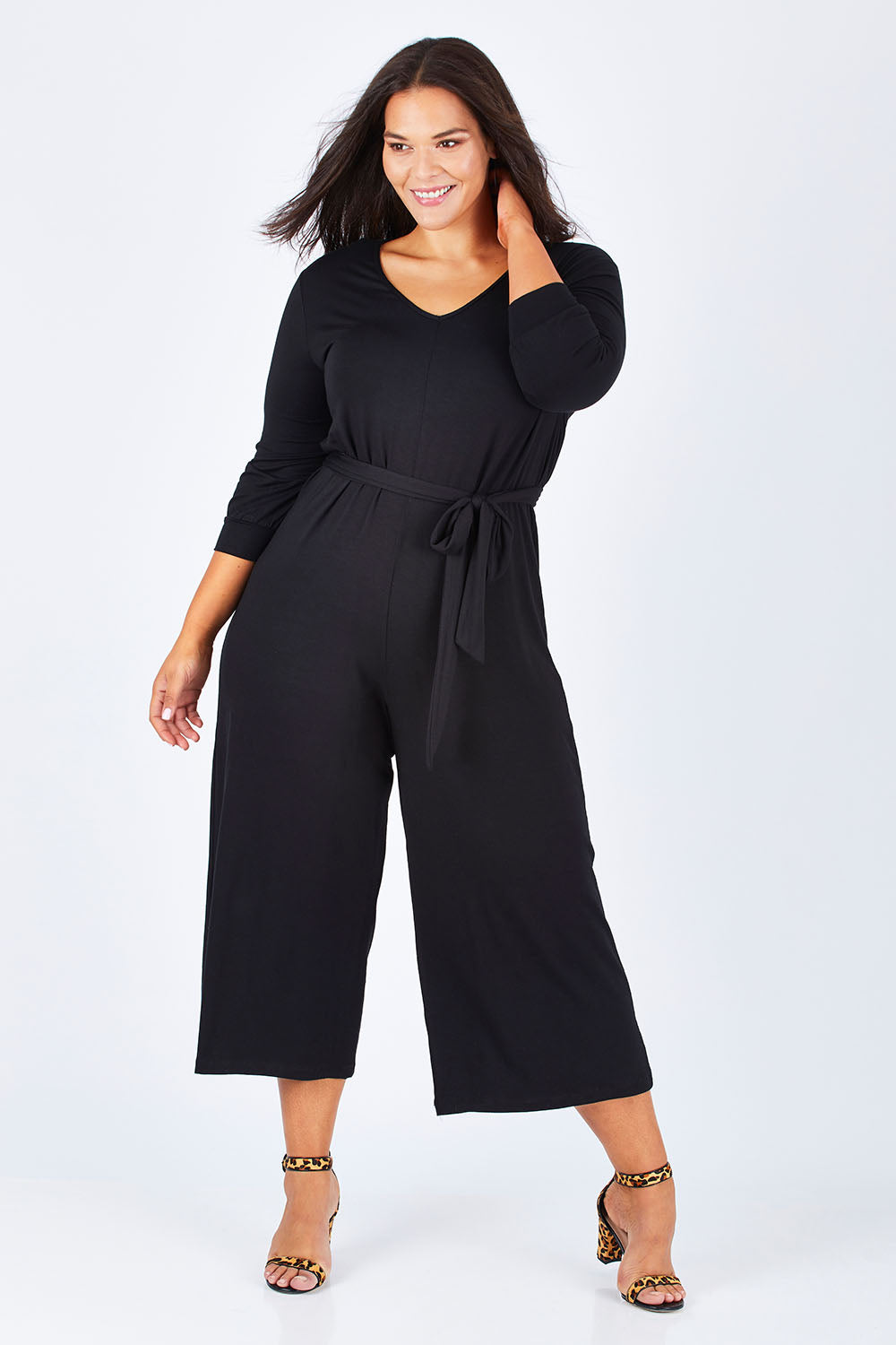 Model Lauren wearing size 16 of the Belle 7/8 Sleeve Knit Jumpsuit With Self Belt in colour Black (Black), from the front, showing the whole outfit