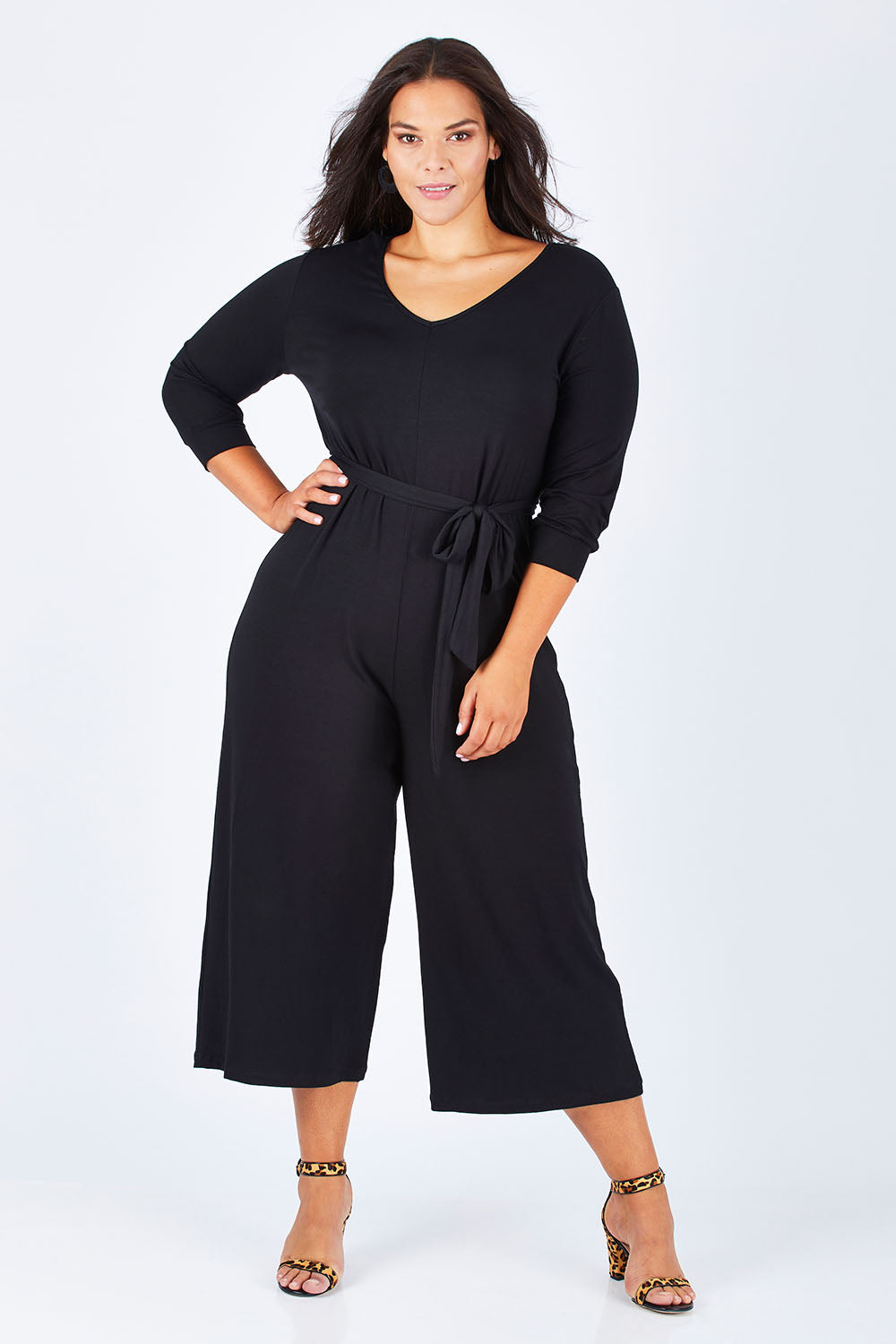 Model Lauren wearing size 16 of the Belle 7/8 Sleeve Knit Jumpsuit With Self Belt in colour Black (Black), from the front, showing the whole outfit
