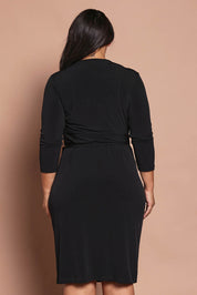 Model Ashleigh wearing size 16 of the Belle Basic Wrap Dress in colour Black (Black), from the back