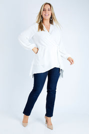 Model Jess wearing size 12 of the Belle Flowy Blouse in colour Offwhite (White), from the front, showing the whole outfit