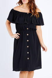 Model Laura wearing size 12 of the Belle Off Shoulder Button Through Dress in colour Black (Black), from the front, cropped image