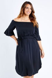 Model Laura wearing size 12 of the Belle Waist Tie Dress in colour Black (Black), from the front, cropped image