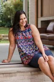 Model Lauren wearing size 16 of the Belle Aztec Trapeze Top in colour Aztec (Red), from the front, showing the whole outfit