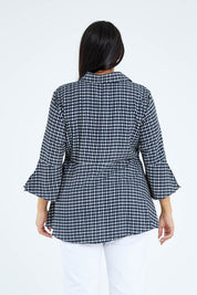 Model Sasha-Lee wearing size 16 of the Belle Seam Detail Check Blouse in colour Check (Blue), from the back