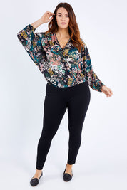 Model Laura wearing size 12 of the Belle Blossom Floral Wrap Top in colour Blossom, from the front, showing the whole outfit