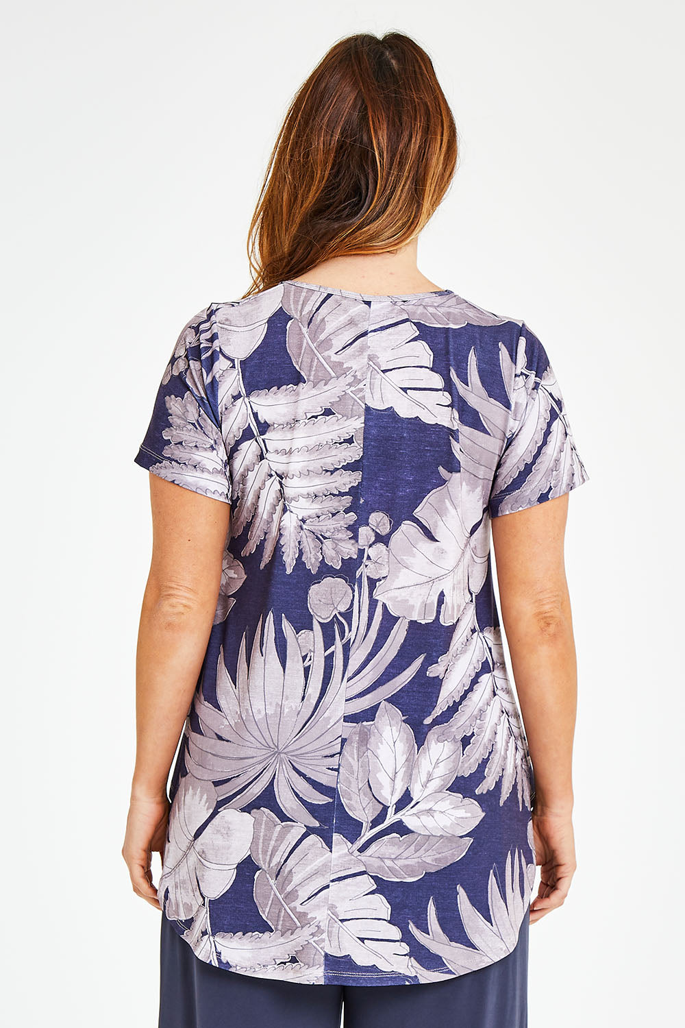 Model Laura wearing size 12 of the Belle Fern Print Top in colour Fern (Blue), from the back