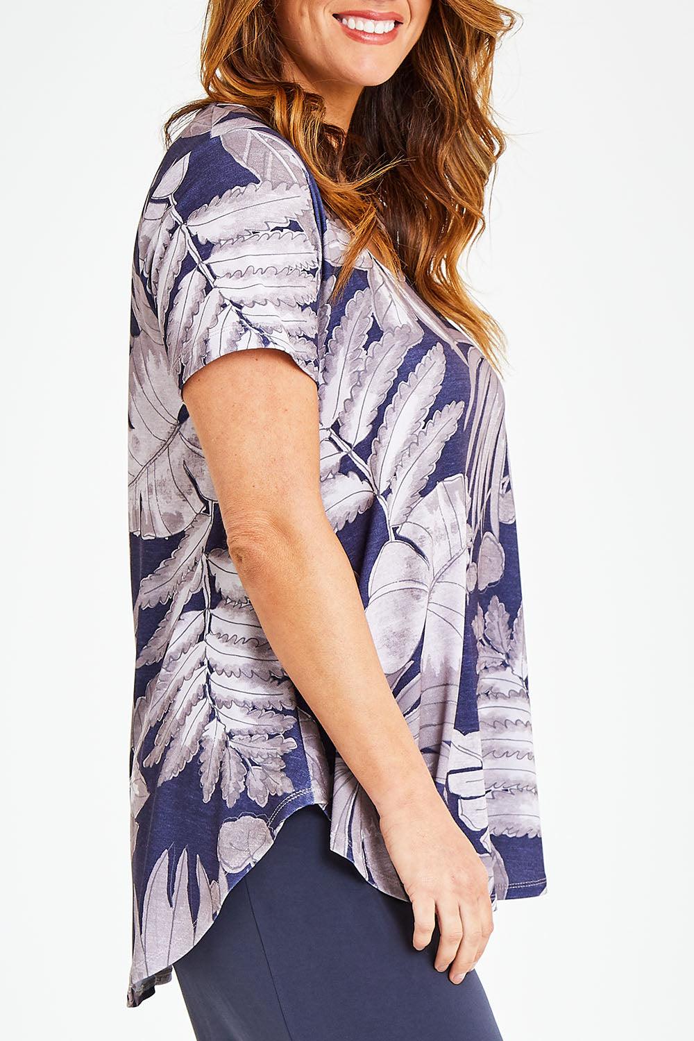 Model Laura wearing size 12 of the Belle Fern Print Top in colour Fern (Blue), from the front, cropped image