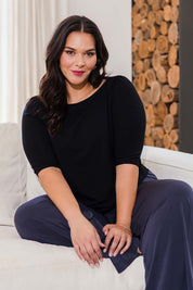Model Lauren wearing size 16 of the Belle Boat Neck Tee in colour Black (Black), from the front, showing the whole outfit