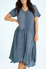 Model Laura wearing size 12 of the Belle Check Maxi Dress in colour Check (Blue), from the front, cropped image