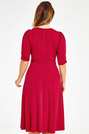 Model Laura wearing size 14 of the Belle Jersey Dress in colour Red (Red), from the back