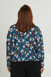 Model Monique wearing size 14 of the Belle Hip Knot Printed Tee in colour Tealfleur (Green), from the back