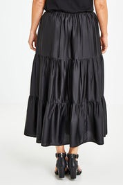 Model Laura wearing size 12 of the Belle Slinky Tiered Skirt in colour Black (Black), from the back