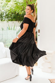 Model Palatina wearing size 16 of the Belle Slinky Tiered Skirt in colour Black (Black), from the front, showing the whole outfit