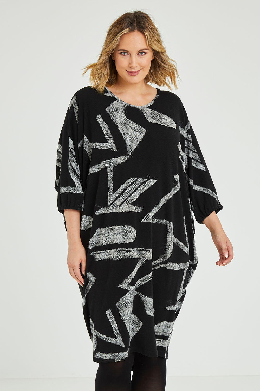 Model Jess wearing size 12 of the Belle Abstract Warm Knit Dress in colour Abstract (Black), from the front, cropped image