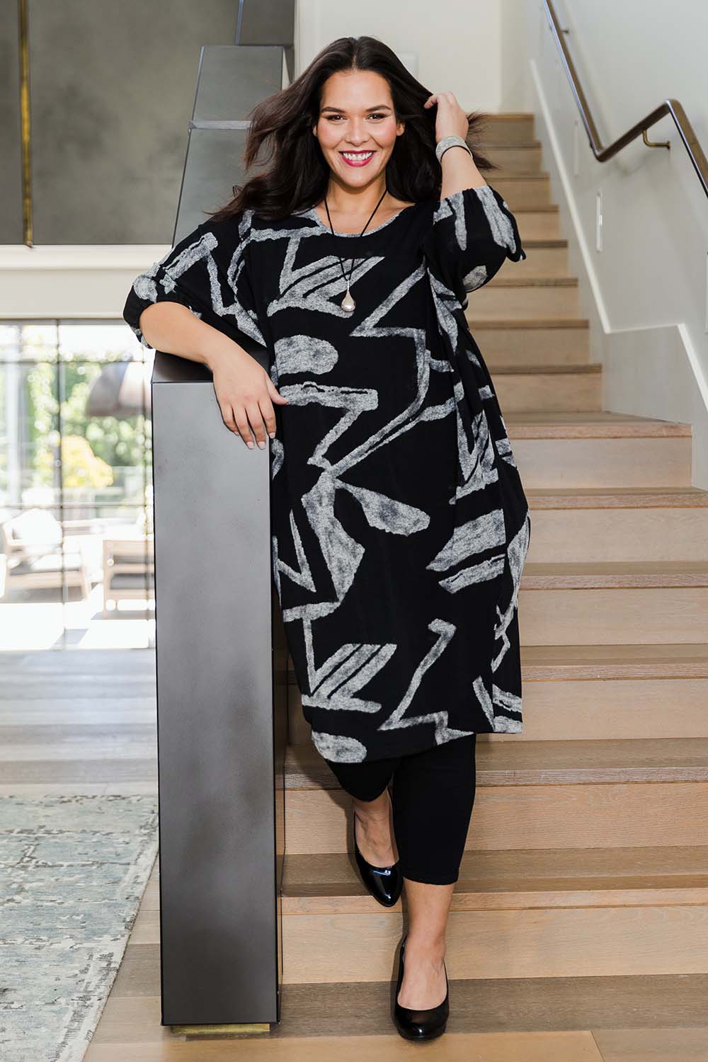 Model Lauren wearing size 16 of the Belle Abstract Warm Knit Dress in colour Abstract (Black), from the front, showing the whole outfit