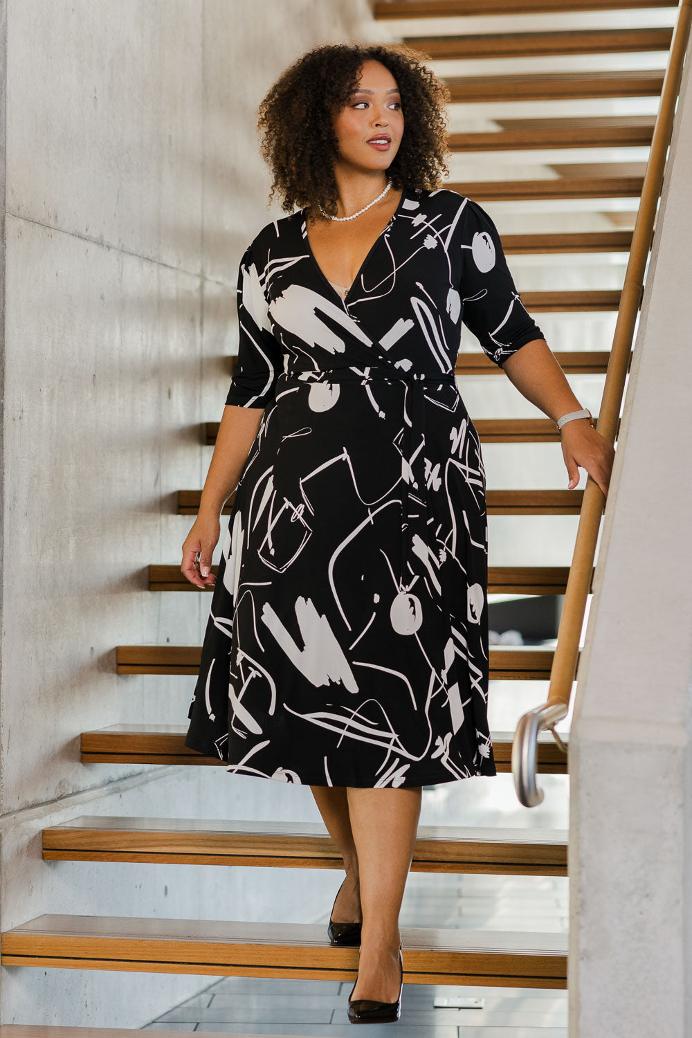 Model Alexis wearing size 18 of the Belle X Over Full Skirt Dress in colour Blackwhite (Black), from the front, showing the whole outfit