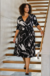 Model Alexis wearing size 18 of the Belle X Over Full Skirt Dress in colour Blackwhite (Black), from the front, showing the whole outfit