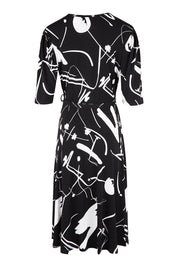 Product shot of the Belle X Over Full Skirt Dress in colour Blackwhite (Black), from the back