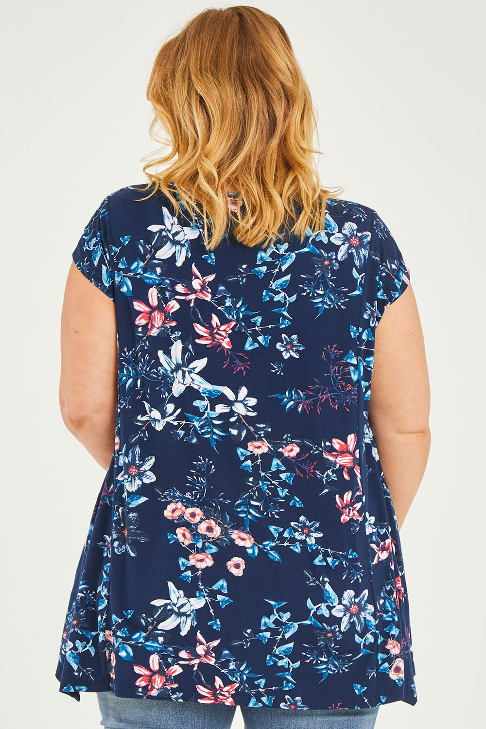 Model Caitlin wearing size 20 of the Belle Printed Drape Tee in colour Floral (Blue), from the back