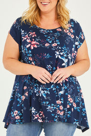 Model Caitlin wearing size 20 of the Belle Printed Drape Tee in colour Floral (Blue), from the front, cropped image