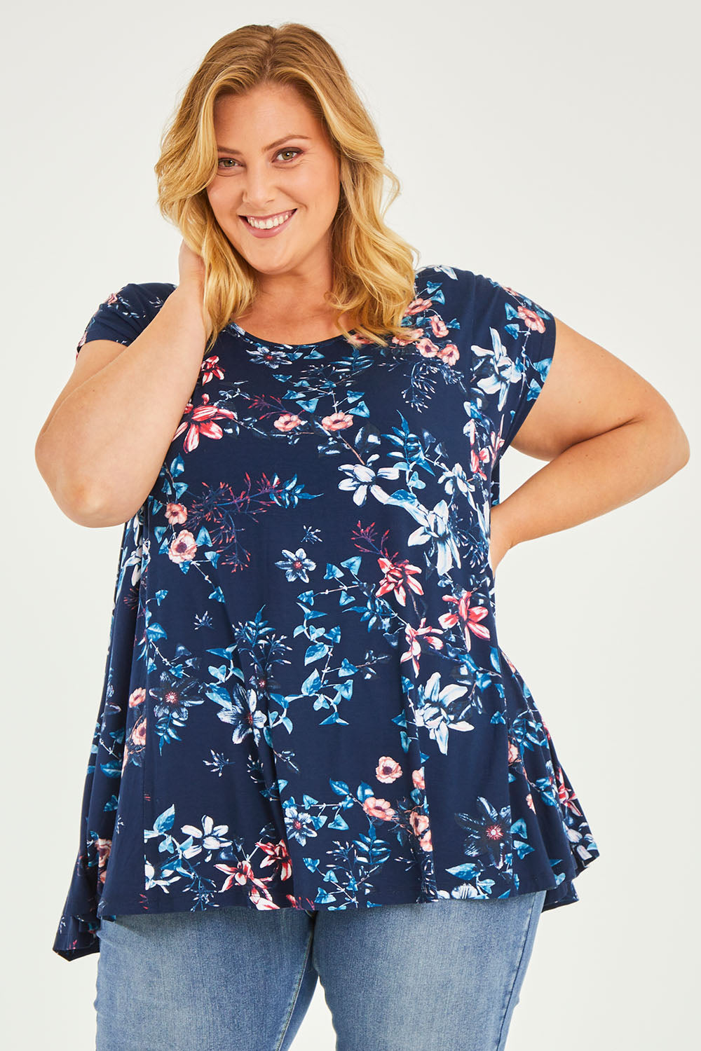 Model Caitlin wearing size 20 of the Belle Printed Drape Tee in colour Floral (Blue), from the front, cropped image