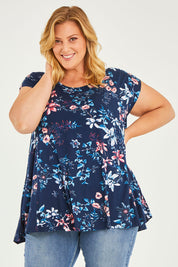 Model Caitlin wearing size 20 of the Belle Printed Drape Tee in colour Floral (Blue), from the front, cropped image